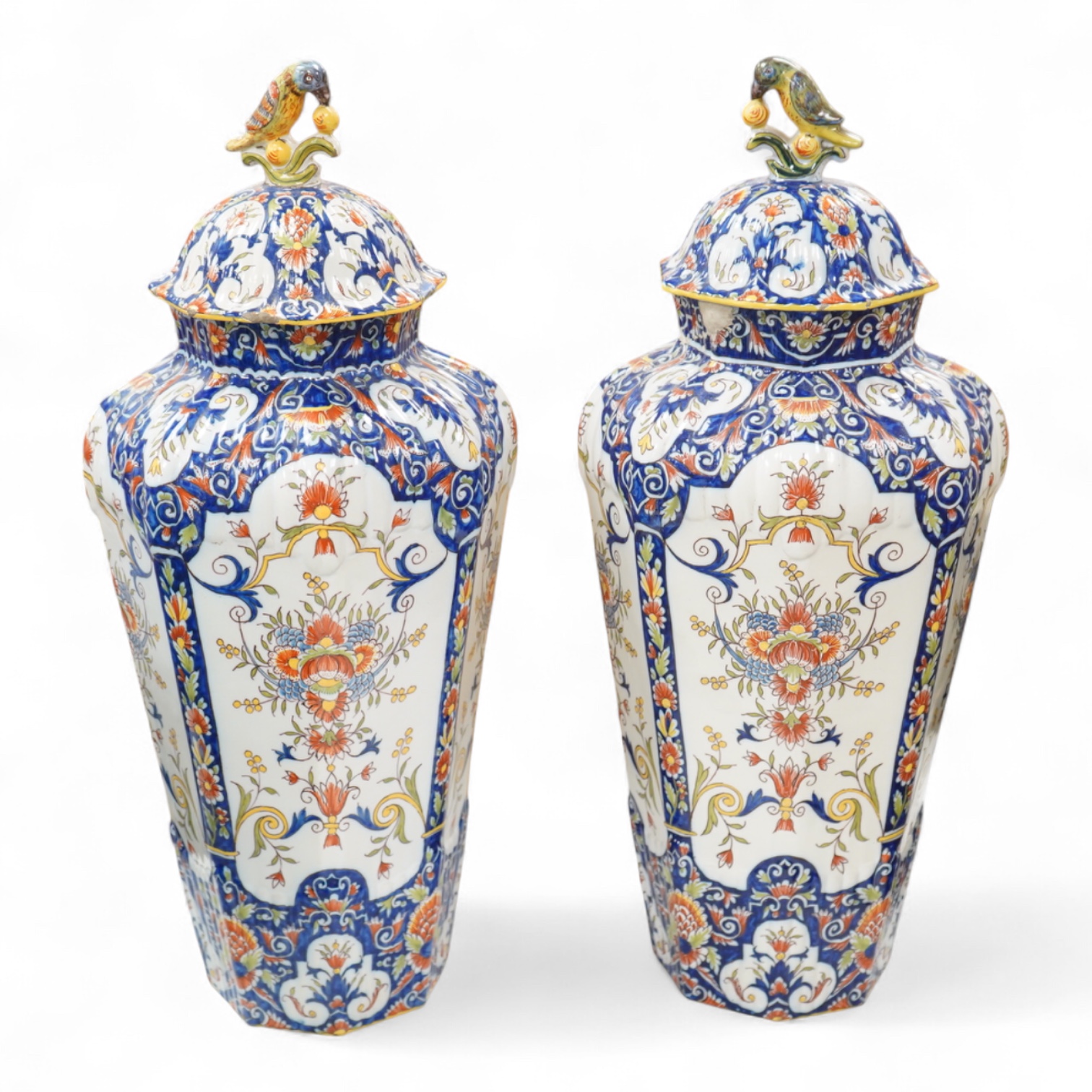 A pair of early 20th century Rouen faience vases and covers, the knops in the form of birds, 49cm high